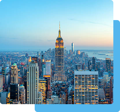 The illuminated New York City skyline at dusk, showcasing the city's iconic buildings and vibrant atmosphere